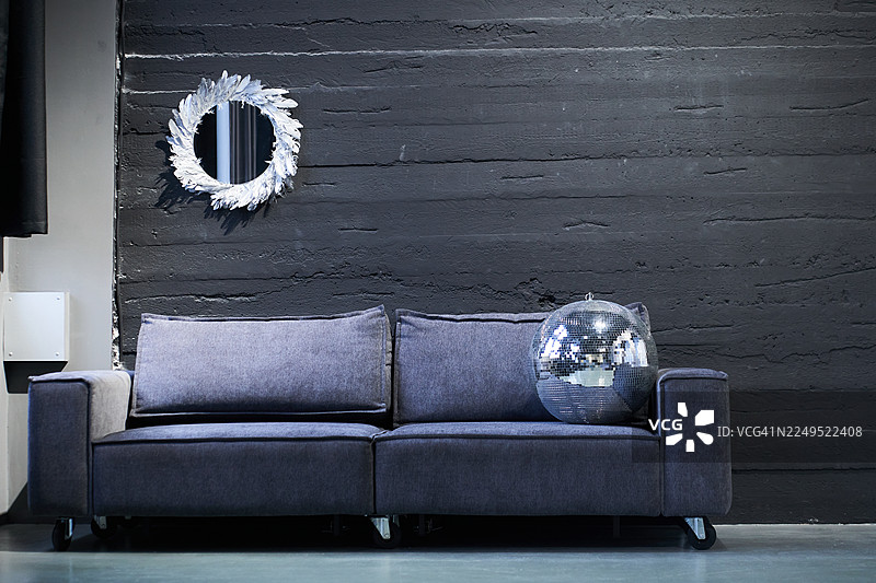 室内的一部分，配有沙发、镜子和用于展示艺术品的复制空间。图片素材