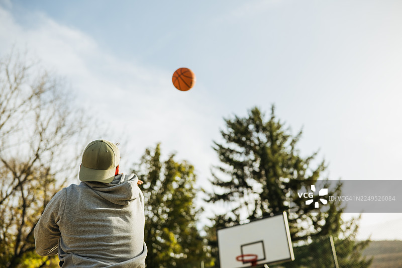 中年男性在街头打篮球，玩得很开心。图片素材