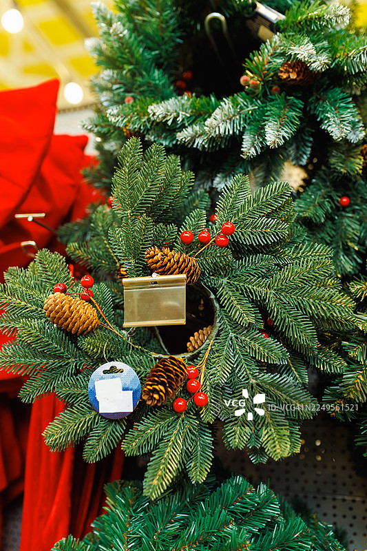 商店橱窗里装饰着松果和红色浆果的节日圣诞花环图片素材