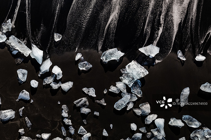 冰岛杰古沙龙冰河湖（钻石海滩）黑色沙滩上的冰块，航拍视角图片素材