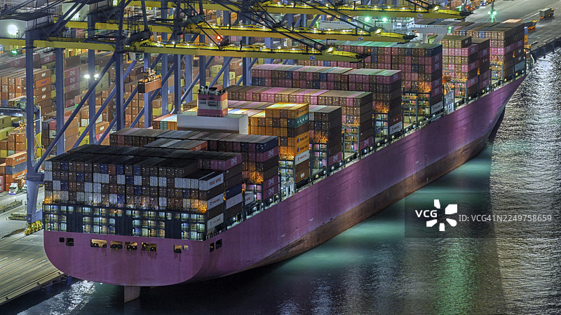 夜间集装箱船在仓库装货的航拍镜头图片素材