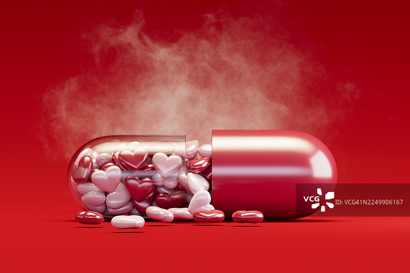 情人节概念，药丸胶囊里的心形，背景为红色图片素材