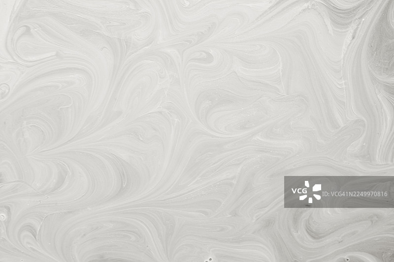 抽象漩涡纹理背景，带有浅灰色大理石般的流动图案图片素材