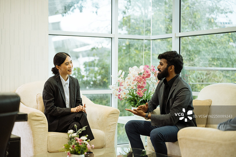 一群穿着得体的商务人士在现代酒店大堂一起工作图片素材