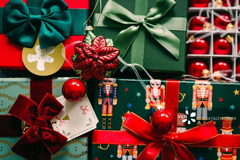 装饰有红色蝴蝶结和闪亮装饰物的节日圣诞礼物包装图片素材
