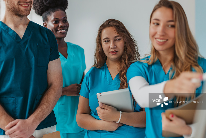 医务人员在白天医院环境中准备轮班时进行讨论图片素材