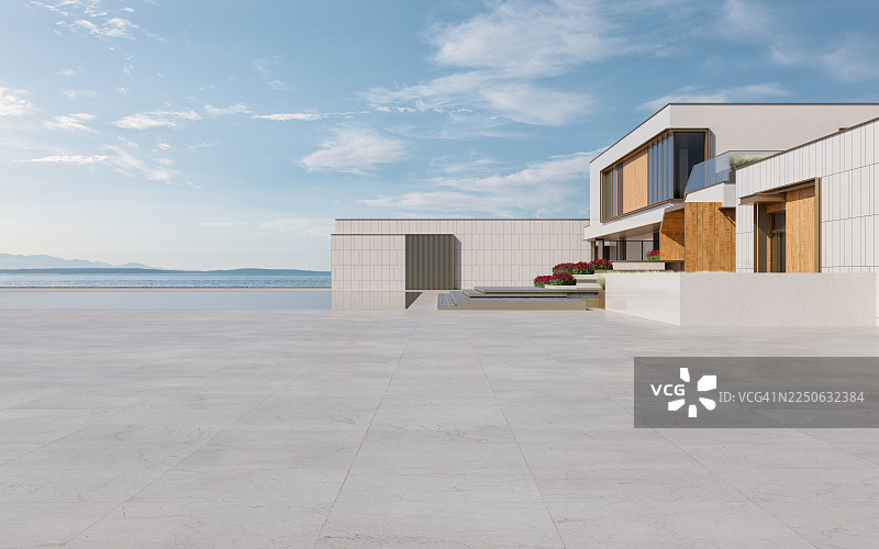 现代海滨别墅，前方有开放的铺砌区域图片素材