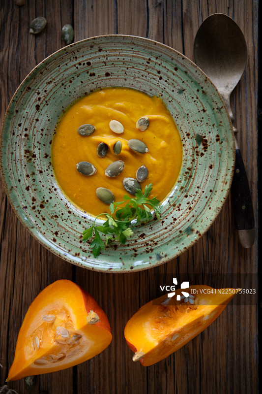乡村风格碗中南瓜汤配南瓜籽和香草的视角图片素材
