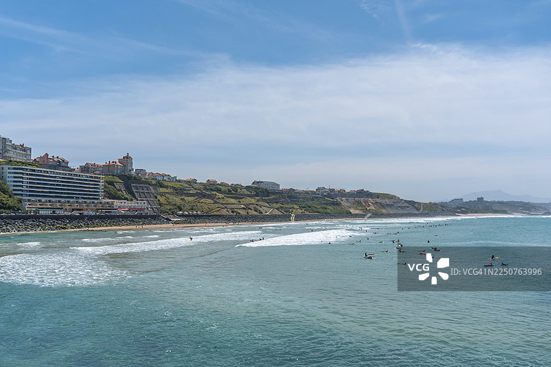 夏日午后，冲浪者云集的巴斯克海岸海滩。法国大西洋比利牛斯省比亚里茨市。图片素材