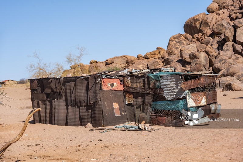简陋的贫民窟，由波纹铁皮和木材建成，沙漠景观，光秃秃的土地，点缀着堆叠岩石的山丘，布兰德堡，埃龙戈，达马拉兰，纳米比亚图片素材