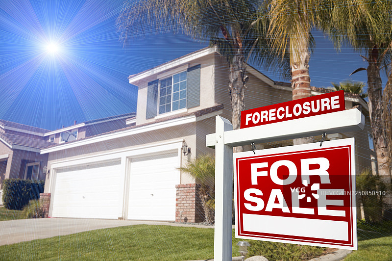 房屋前有红色的止赎出售房产标志，天空中有蓝色的星形爆炸。图片素材