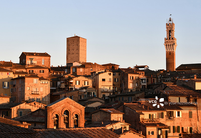 日落时分从圣多明尼哥拍摄的锡耶纳全景，可以看到曼吉亚塔楼，前景是圣凯瑟琳钟楼图片素材