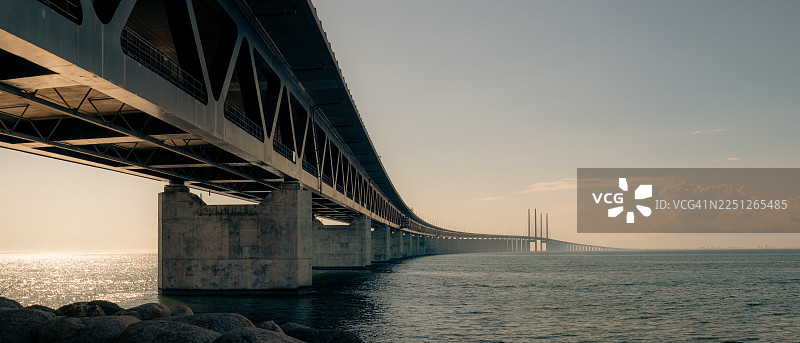 日落时分，厄勒海峡大桥跨海连接丹麦和瑞典的低角度视图图片素材