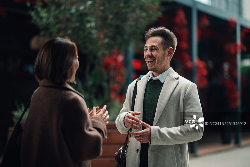 年轻人在户外开心地大笑交谈，享受着谈话的乐趣图片素材