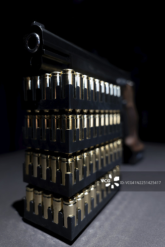 瑞士制造的优雅半自动9毫米手枪，倚靠在子弹弹药上图片素材