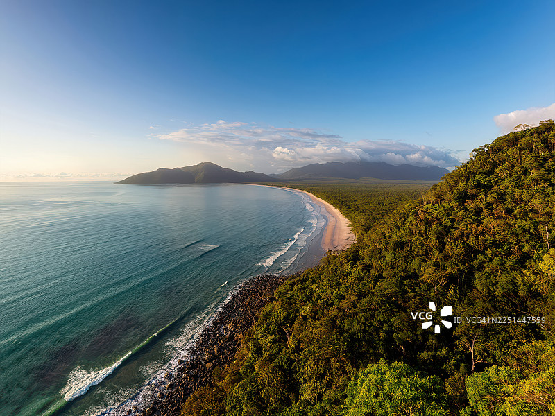 令人惊叹的原始热带海岸线鸟瞰图，郁郁葱葱的绿色雨林与绿松石般的海水在晴朗的蓝天下交汇，澳大利亚道格拉斯角，珊瑚礁角图片素材