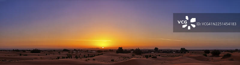 摩洛哥撒哈拉沙漠上宁静的日出，天空闪耀着鲜艳的色彩图片素材
