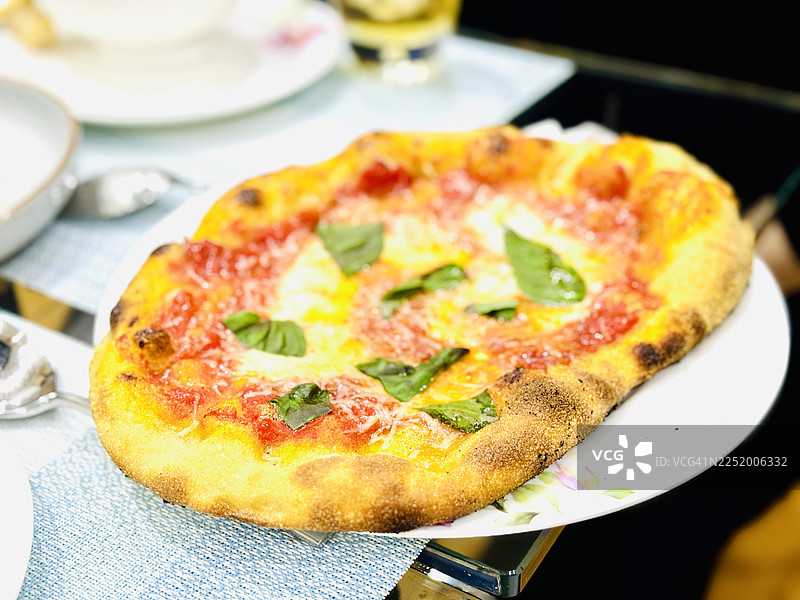 盘子里的番茄马苏里拉奶酪披萨配罗勒叶图片素材