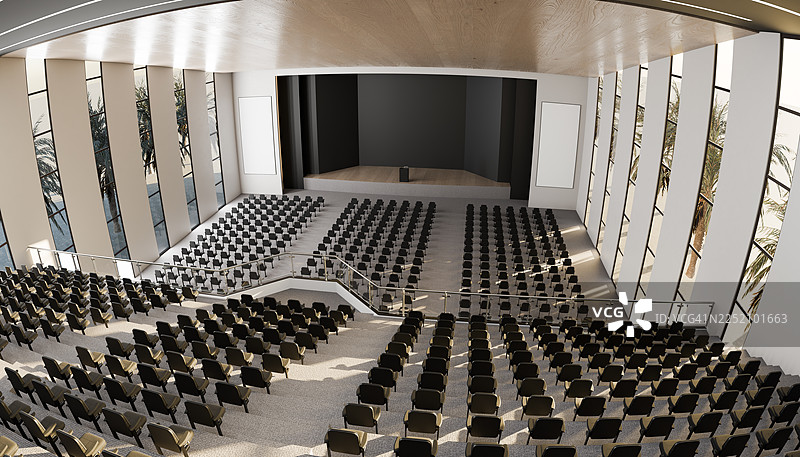 空旷的现代室内礼堂，设有舞台和成排座椅图片素材