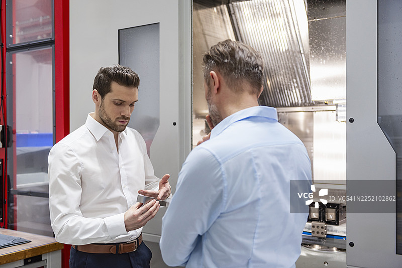 在生产车间举行的商业会议，讨论机械设备图片素材
