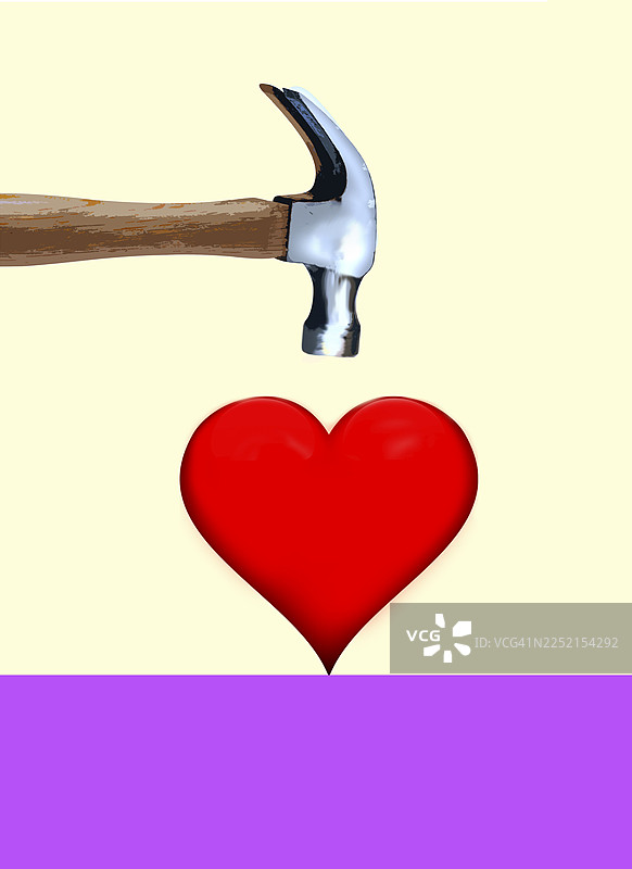 锤子即将击中心脏，象征着心碎与爱情的概念图片素材