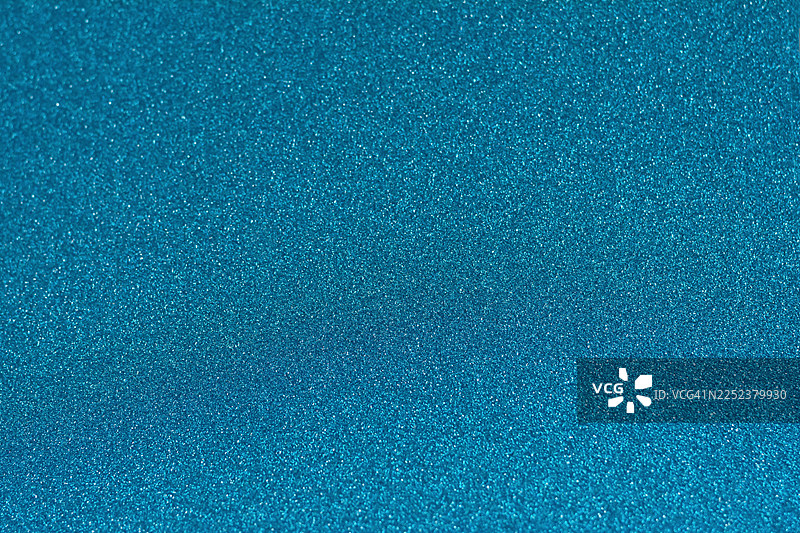 节日背景，蓝色，闪光，闪烁，闪闪发光，纹理闪闪的圣诞节散景。新年、生日的概念。图片素材