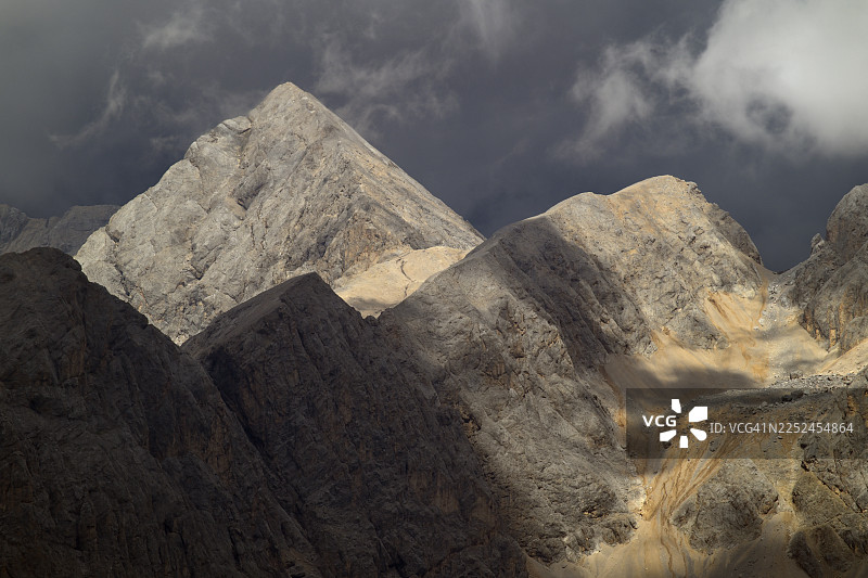 莫埃纳，圣佩莱格里诺山口，意大利，多云天空下的崎岖岩石构造的戏剧性低角度视图图片素材