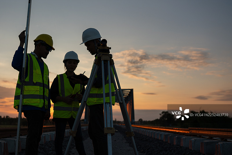 日落时分建筑团队在项目工地合作，城市环境剪影视角，团队合作概念图片素材