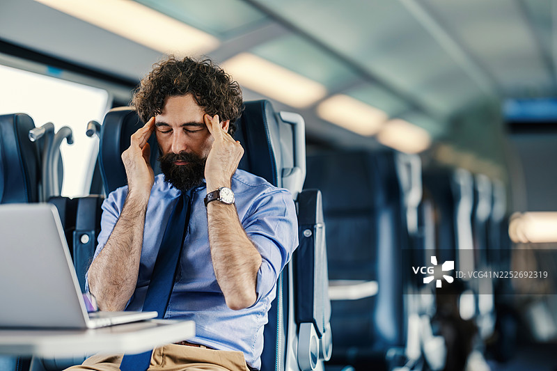 商务人士在火车上通勤时头痛图片素材