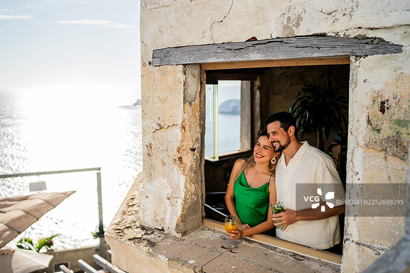 一对情侣在灯塔上眺望风景图片素材