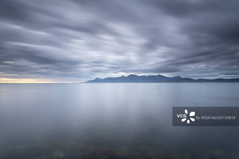 挪威诺尔兰郡的韦斯特峡湾（靠近博多）以其戏剧性的氛围令人印象深刻。乌云掠过水面，营造出神秘的氛围。崎岖的悬崖和雄伟的山脉倒映在宁静的峡湾中，景色壮丽。图片素材