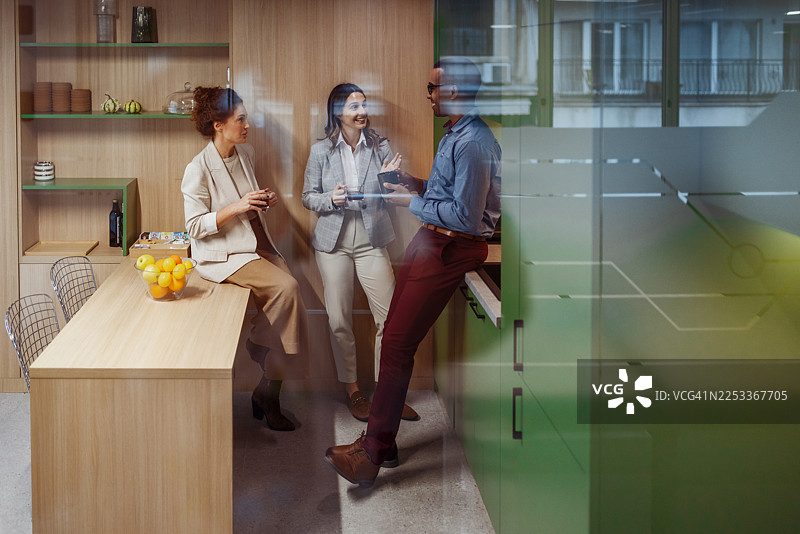 办公室休息场景，同事们隔着玻璃交谈图片素材