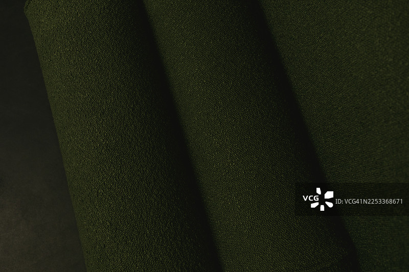 深绿色织物纹理。图片素材