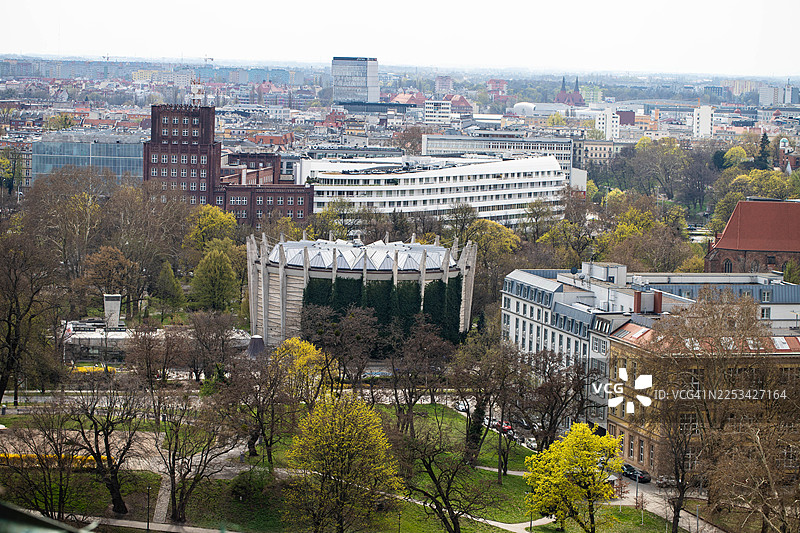 阴天下的城市高视角，有各种建筑、绿色树木和城市公园区域图片素材