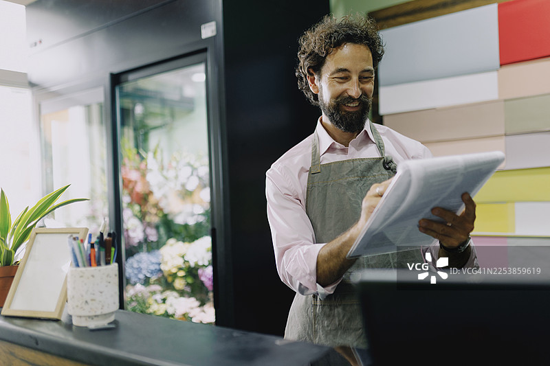 花店店主在花店写备忘录图片素材