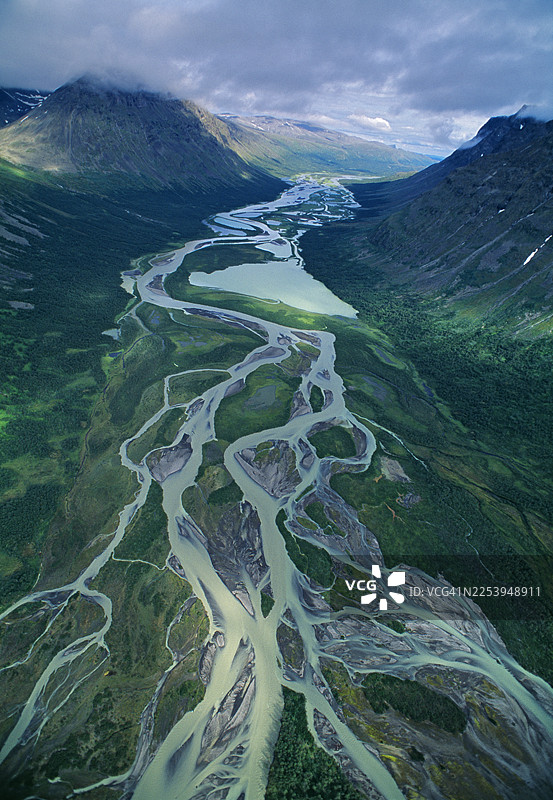 多云天空下，群山之间宁静的湿地的鸟瞰图图片素材