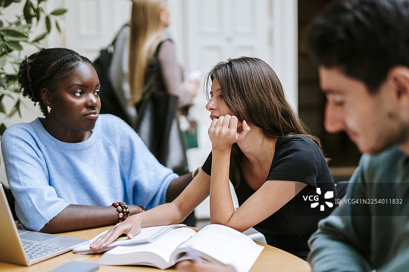 几位女性朋友在大学校园里认真学习图片素材