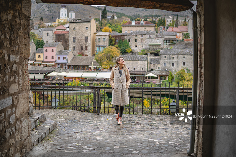 年轻女子在波斯尼亚和黑塞哥维那的莫斯塔尔进行观光旅行，探索这座历史悠久的城市街道图片素材