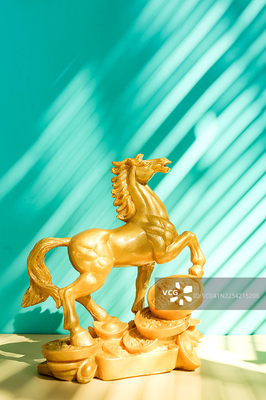 金色风水马，背景为绿松石色，带有对角线阴影图片素材