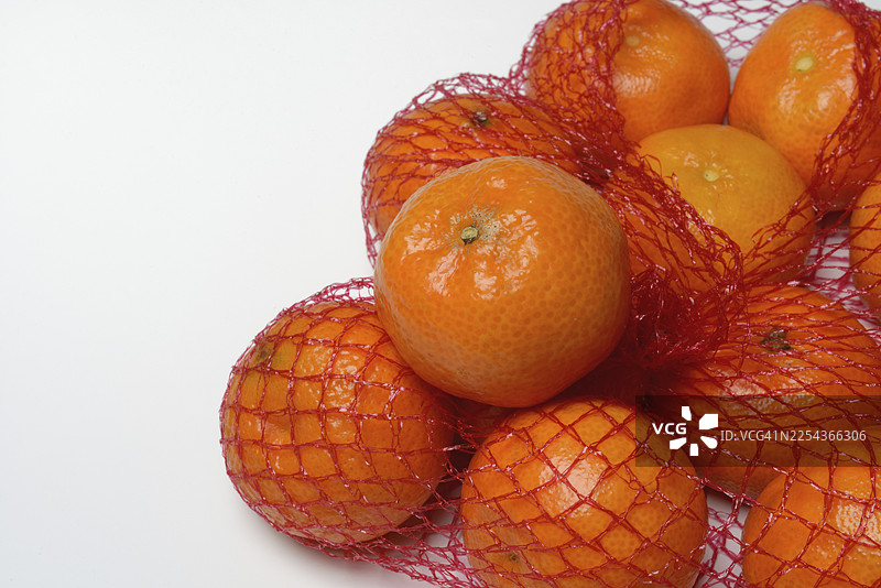 网袋里的橘子，热带水果图片素材