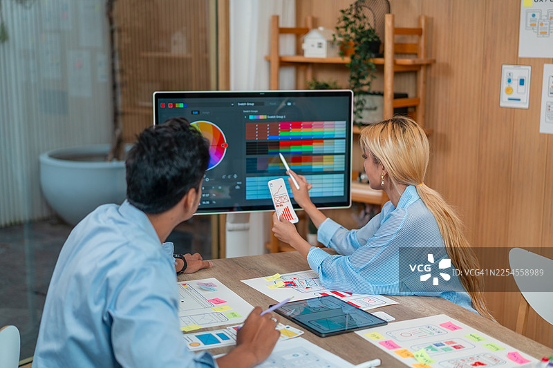 UX/UI 设计师们正在讨论和构思网站和移动应用原型线框图图片素材