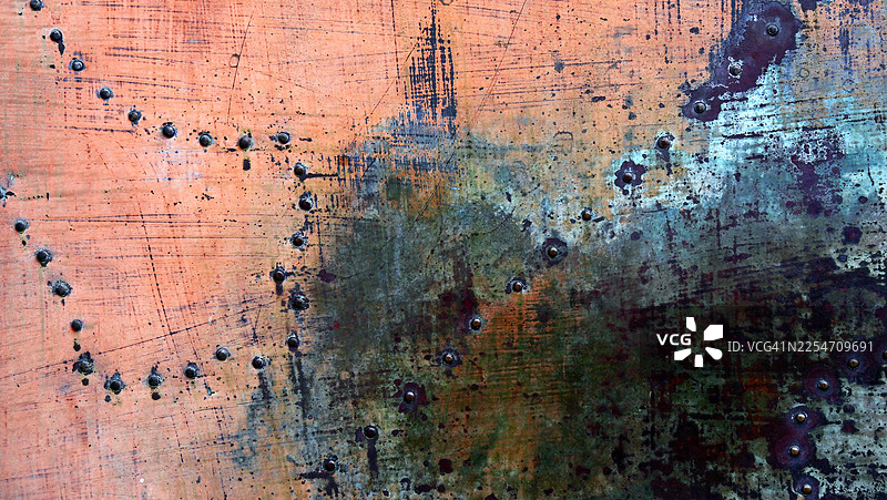 铆接金属板的特写，呈棕色、做旧和氧化处理。粗糙的纹理。图片素材