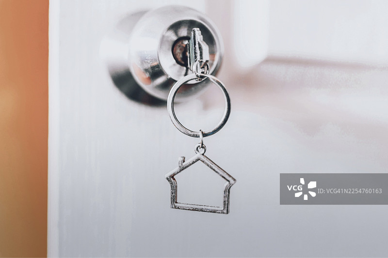 特写镜头：银色门钥匙，银色门钥匙插在门锁里，家居概念图片素材