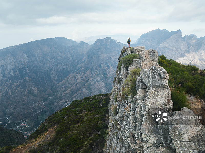 徒步者站在岩石山脊上，眺望大皮科峰图片素材