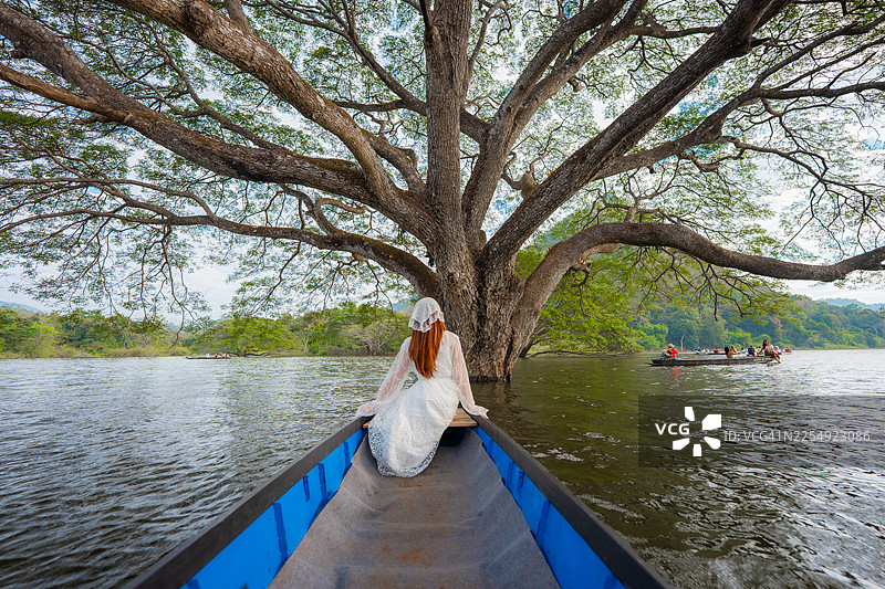 一位迷人的女子前往清迈，探访湖中的雨树图片素材