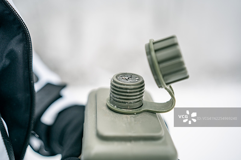 军绿色水壶，瓶盖已打开——特写户外生存装备，用于徒步和露营图片素材