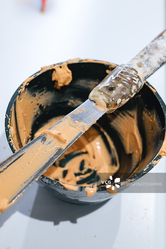 白色表面上的染发刮刀和调色碗图片素材