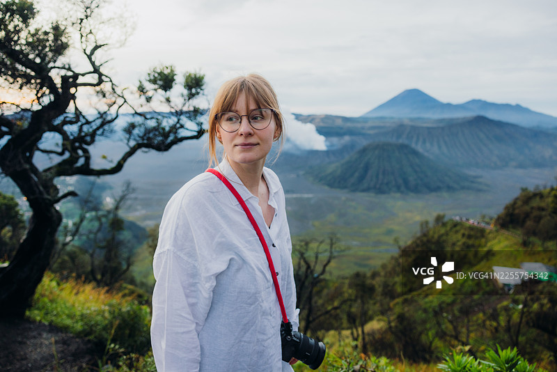 一名女子在印度尼西亚欣赏婆罗摩火山和塞梅鲁火山壮丽的日出景色图片素材