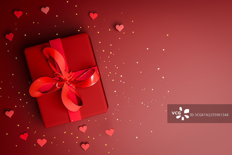 红色礼品盒，带有丝带、心形和金色纸屑，置于渐变背景上图片素材