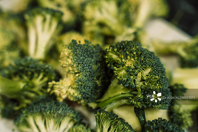 新鲜西兰花小朵特写在砧板上，选择性对焦图片素材